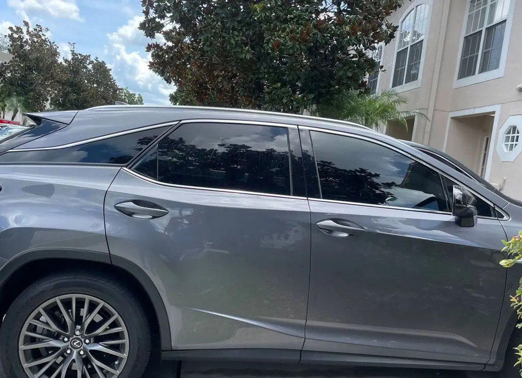 Gray Lexus RX with freshly tinted windows in a driveway