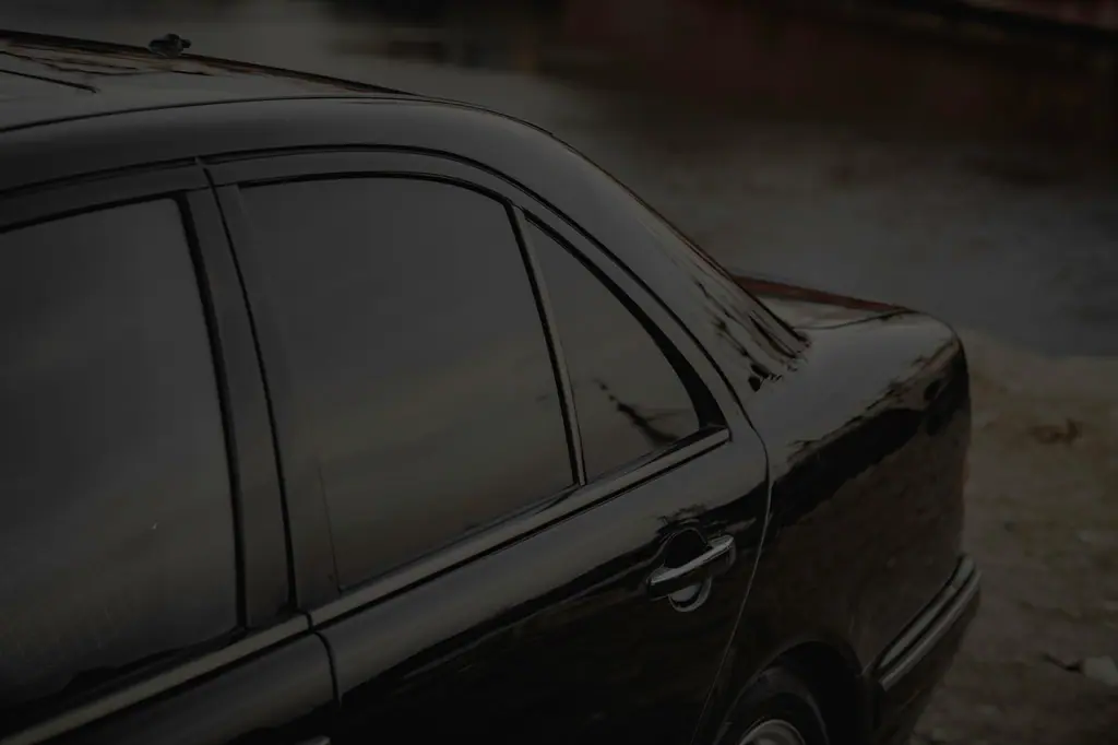 Black sedan with dark tinted side windows